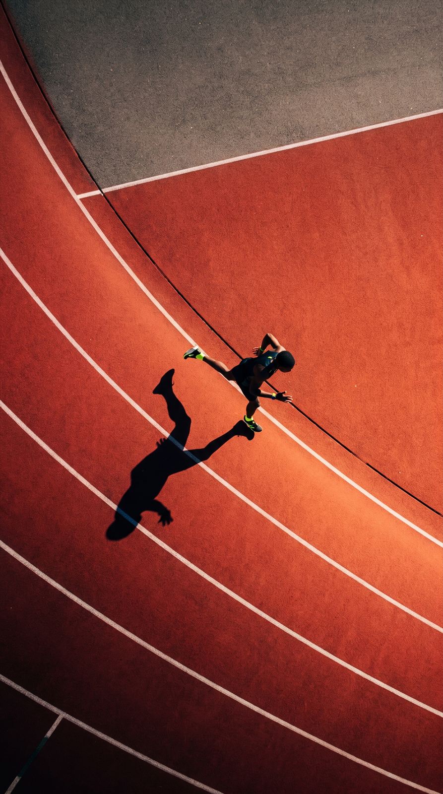 A runner on a red track, seen from above